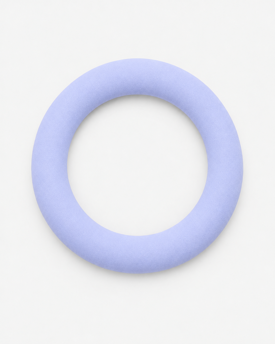 A pale periwinkle lavender flying ring dog toy seen from above on a light grey background.