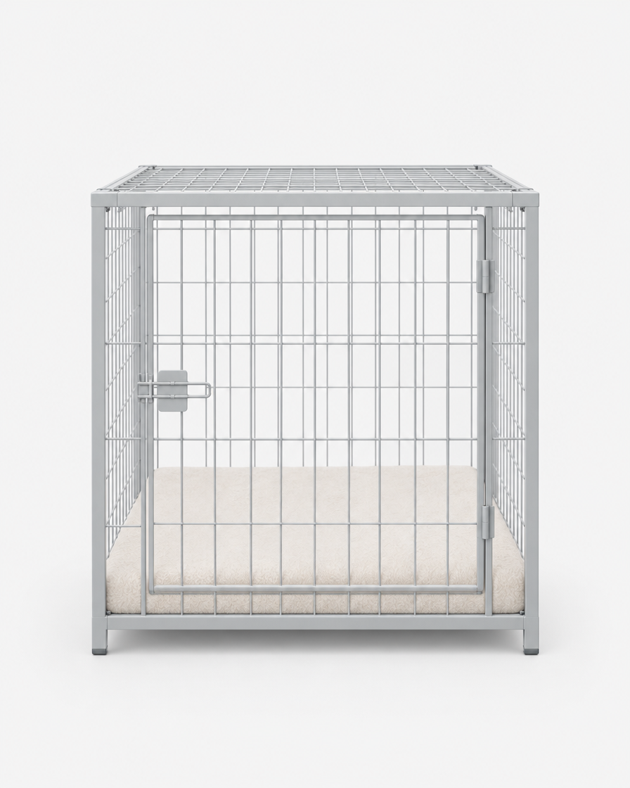 Front view of a light grey steel wire dog crate with a hinged wire door and a fitted cream cushion pad on a plain light grey background.