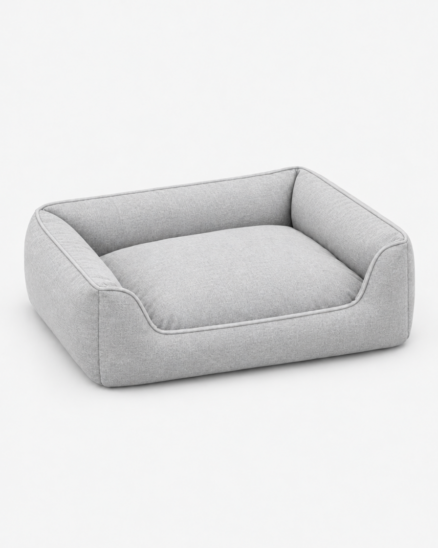 The light grey bolster dog bed from the set shown on its own from a three-quarter angle on a light grey studio background.